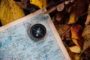 Compass resting on a map representing direction, judgement and disciplined thought.