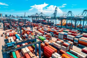 Shipping containers moving through a port representing modern organizational complexity.